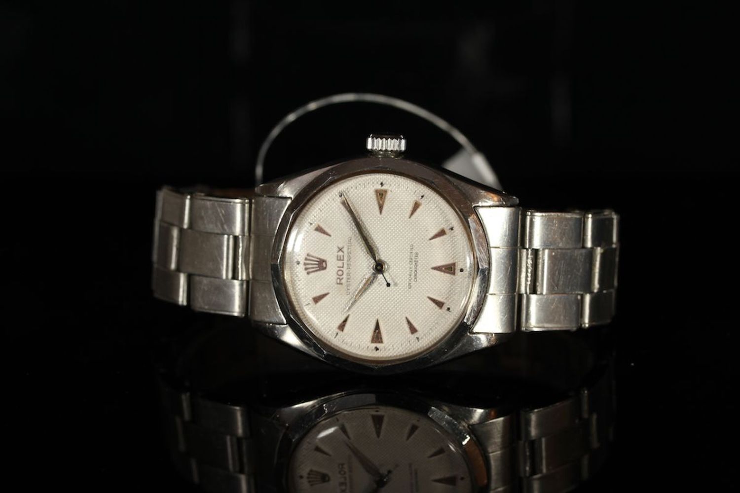 GENTLEMENS ROLEX SEMI BUBBLE BACK WRISTWATCH, circular honeycomb dial with arrow hour markers,