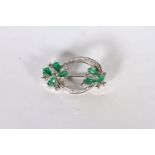 14CT WHITE GOLD EMERALD AND DIAMOND BROOCH ,PRONG SET AND STYLED AS TWO FLOWERS WITH EMERALD