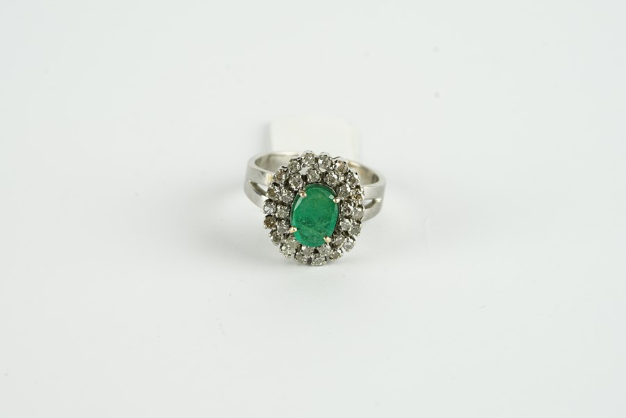 18CT WHITE GOLD EMERALD AND DIAMOND CLUSTER RING,centre stone estimated as 9.2x 3.48mm, diamonds