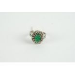 18CT WHITE GOLD EMERALD AND DIAMOND CLUSTER RING,centre stone estimated as 9.2x 3.48mm, diamonds