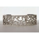 Brilliant cut diamond bangle, brilliant cut diamonds mounted across an open bangle, scrolling centre