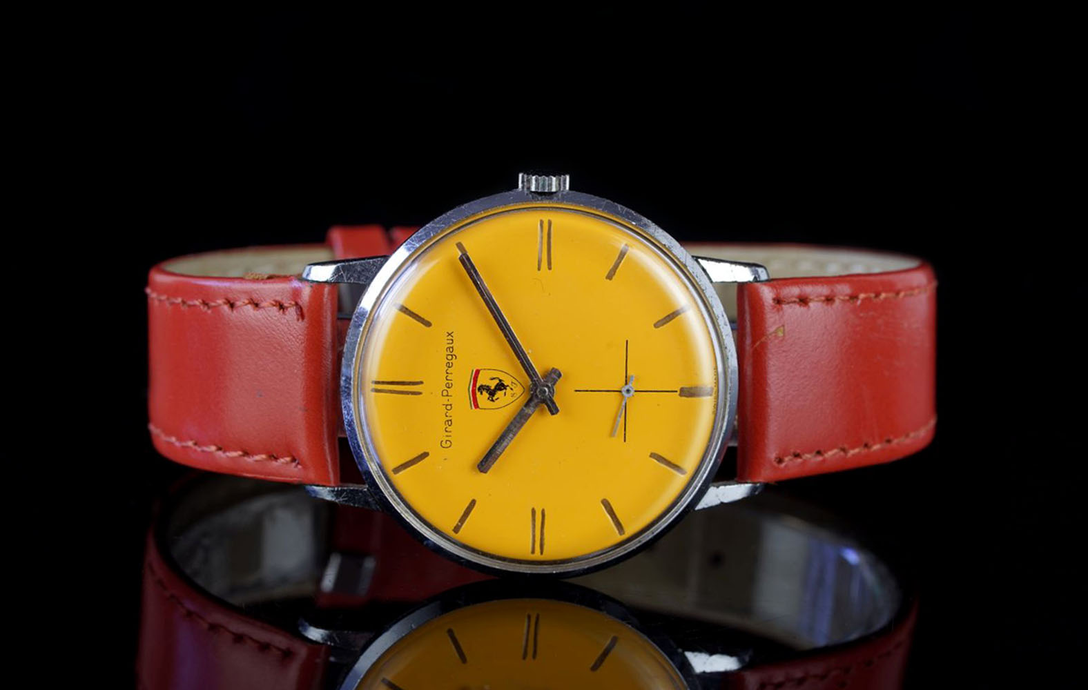 GENTLEMENS GIRARD PERREGAUX WRISTWATCH, circular yellow/orange dial marked with a Ferrari badge,