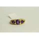 Amethyst and Diamond Ring, set with 3 amethysts and 4 diamonds, stamped 18ct yellow gold, finger
