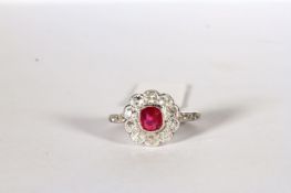 Ruby and Diamond Flower Ring, set with a ruby approximately 0.70ct, surrounded by diamonds totalling