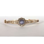 Sapphire and Diamond bangle, set with a sapphire estimated 3.00ct, surrounded by diamonds