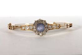 Sapphire and Diamond bangle, set with a sapphire estimated 3.00ct, surrounded by diamonds