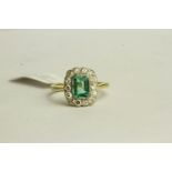 Emerald and Diamond Ring, set with a centre emerald approximately 0.64ct, surrounded by 14