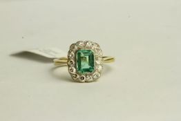 Emerald and Diamond Ring, set with a centre emerald approximately 0.64ct, surrounded by 14