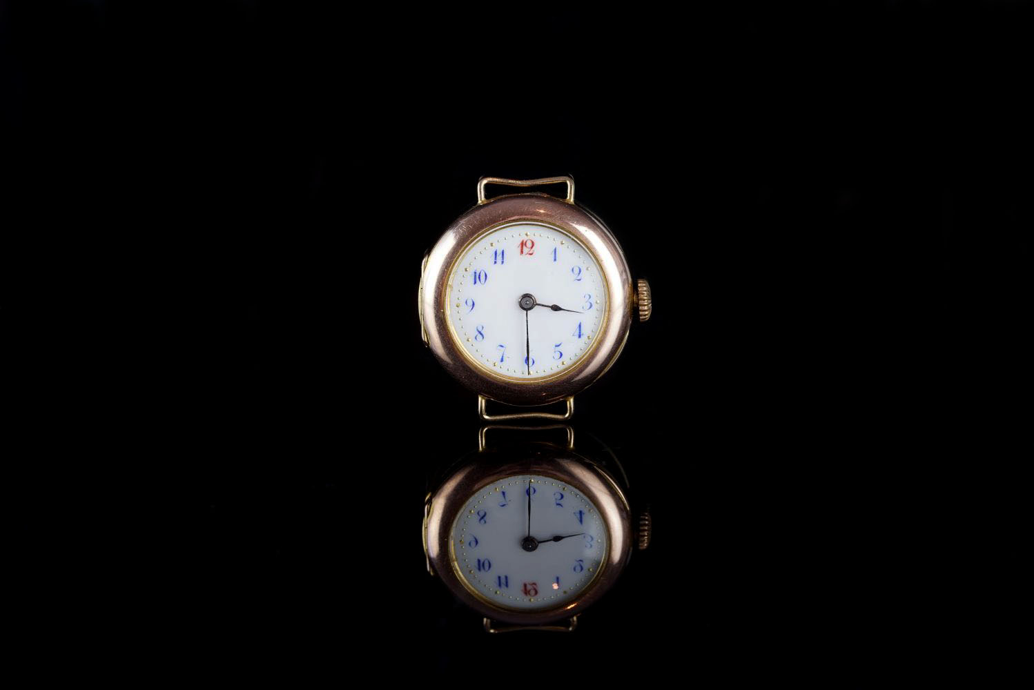 LADIES 9CT GOLD TRENH WRISTWATCH, circular white dial with blue Arabic numerals and a red twelve,