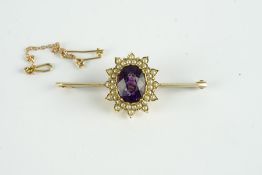 9CT AMETHYST AND PEARL BROOCH, centre stone estimated as 10x9.1mm, length 4.5cms, stamped 9ct not