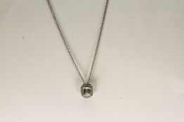 18CT WHITE GOLD EMERALD CUT DIAMOND NECKLACE ESTIMATED AS 0.51CT CENTRE STONE, estimated colour G,