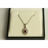 Ruby and Diamond Cluster Necklace, set with 1 oval cut ruby approximately 0.33ct
