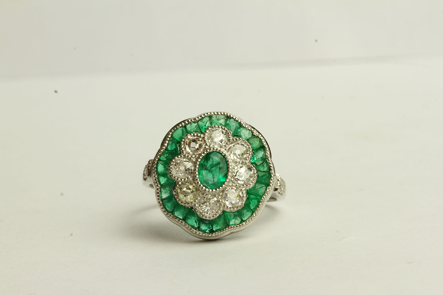 Emerald and Diamond Daisy Style Ring, set with emeralds totalling approximately 1.45ct