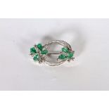 14CT WHITE GOLD EMERALD AND DIAMOND BROOCH ,PRONG SET AND STYLED AS TWO FLOWERS WITH EMERALD