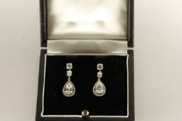 Diamond drop earrings, pear cut diamonds each set within a cluster of brilliant cut diamonds,