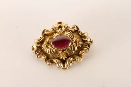 Victorian Brooch, Cabochon garnet centre floral gold work detail, approximately 8.6g gross, tested