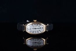 LADIES OMEGA 18CT GOLD WRISTWATCH CIRCA 1920s, tonneau shaped silver dial with black Arabic numerals