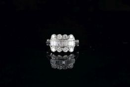 Diamond dress ring, transitional cut and baguette cut diamonds set as three rows, scrolling