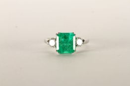 Emerald and Diamond Three Stone ring, central square cut Emerald, 8.2x7.78x5.81 estimated weight 2.