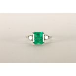 Emerald and Diamond Three Stone ring, central square cut Emerald, 8.2x7.78x5.81 estimated weight 2.