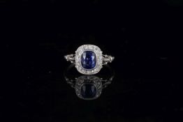 Fine Ceylon Sapphire and diamond cluster ring, central cushion cut sapphire, accompanied by a GCS