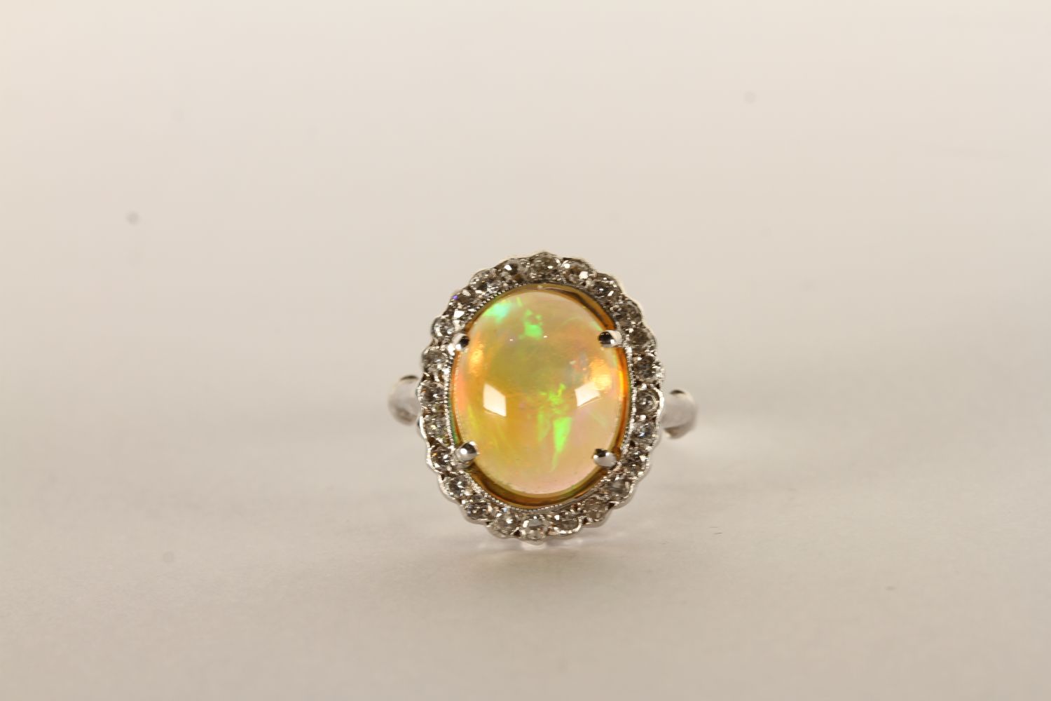 Opal and Diamond Cluster Ring, Cabochon Opal, 12.5x10mm, diamond surround, in 18ct white gold