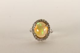 Opal and Diamond Cluster Ring, Cabochon Opal, 12.5x10mm, diamond surround, in 18ct white gold