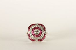 Ruby and Diamond Ring, set with a central diamond, surrounded by a halo of rubies, a halo of