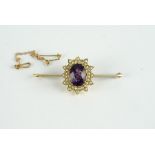 9CT AMETHYST AND PEARL BROOCH, centre stone estimated as 10x9.1mm, length 4.5cms, stamped 9ct not