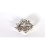 14CT DIAMOND BROOCH FORMED AS AN ABSTRACT SHAPED COCKTAIL BROOCH, set with an estimated 42 round