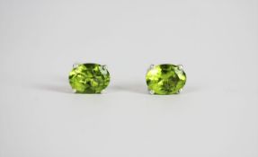 Pair of Peridot Stud Earrings, set with 2 oval cut peridots, 4 claw set, stamped sterling silver