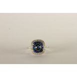 Art Deco Style Sapphire and Diamond Ring, central oval cut sapphire, surrounded by a halo of calibre