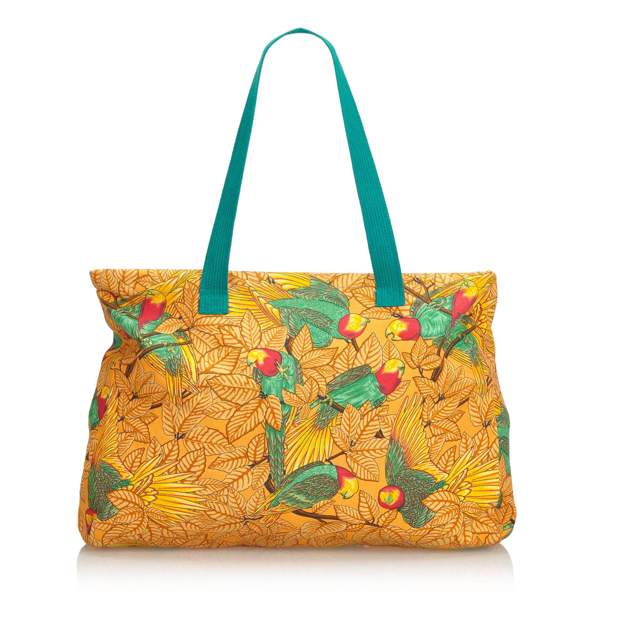 Hermes Printed Canvas Tote Bag, this tote bag features a printed canvas body, flat handles, and an