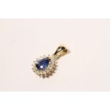 Sapphire and Diamond Pendant, set with a pear cut medium blue sapphire totalling 1.20ct, claw set,
