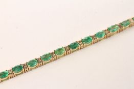 Emerald and Diamond Bracelet, set with 21 oval cut light green emeralds totalling 8.13ct, claw