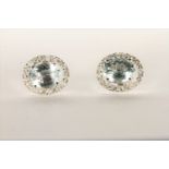 Pair of Aquamarine and Diamond Stud Earrings, set with a total of 2 oval cut light blue