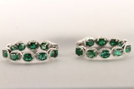 Pair of Emerald and Diamond Hoop Earrings, set with a total of 18 oval cut medium to dark green