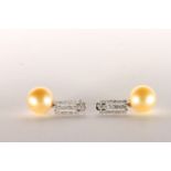 Pair of Pearl and Diamond Drop Earrings, set with 2 golden South Sea Pearls, surrounded by a total