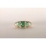 Emerald and Diamond Ring, set with 5 oval cut medium green emeralds totalling 2.00ct, bezel set,