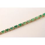 Emerald and Diamond Bracelet, set with 22 oval cut medium green emeralds totalling 7.02ct, claw set,