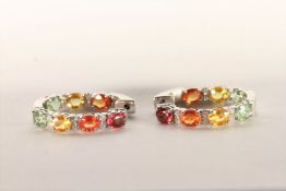 Pair of Multi-Coloured Sapphire and Diamond Hoop Earrings, set with a total of 14 oval cut yellow,