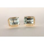 Pair of Aquamarine and Diamond Stud Earrings, set with 2 emerald cut light blue aquamarines