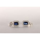 Pair of Sapphire and Diamond Earrings, set with 2 emerald cut dark vivid blue sapphires to the