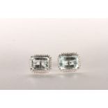 Pair of Aquamarine and Diamond Stud Earrings, set with 2 emerald cut light blue natural