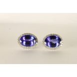 Pair of Tanzanite and Diamond Earrings, each set with an oval cut tanzanite approximately 10.6mm x