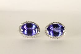 Pair of Tanzanite and Diamond Earrings, each set with an oval cut tanzanite approximately 10.6mm x