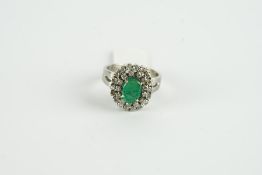 18CT WHITE GOLD EMERALD AND DIAMOND CLUSTER RING,c