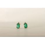 Pair of Emerald and Diamond Earrings, each set with an oval cut emerald, 4 claw set, each set with a