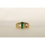 Emerald and Diamond Ring, set with baguette cut emeralds to the centre, surrounded by round