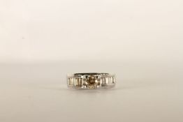 Diamond Ring, centre set with a round brilliant cut diamond, 4 claw set, shoulders set with baguette
